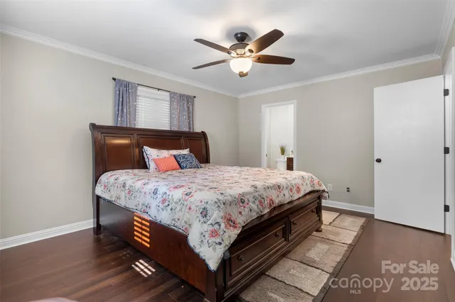 a bedroom with a bed and a ceiling fan