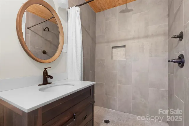 a bathroom with a sink a mirror and vanity