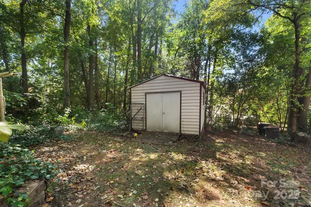 a backyard of a house with barbeque oven and outdoor seating