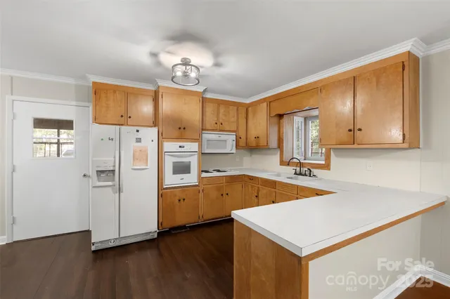 a kitchen with wooden cabinets and center island
