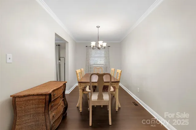 a view of a dining room with furniture and chandelier