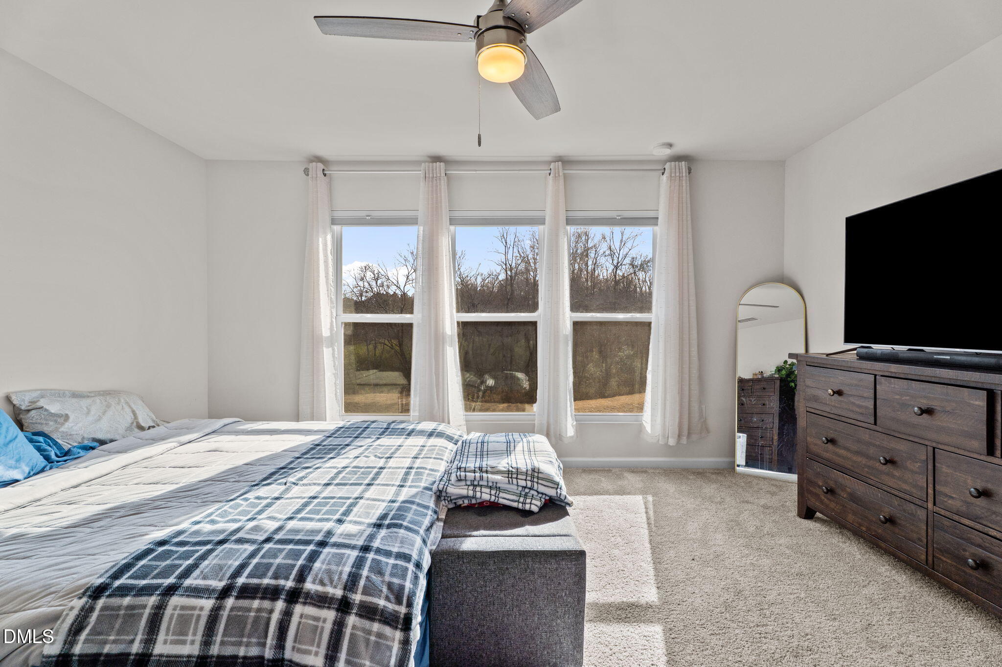 1572 Rhodes Pond Street Wendell, NC 27591 - Photo 16 of 44 a bedroom with a bed and flat screen tv