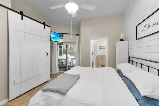 a bedroom with a bed and a large window