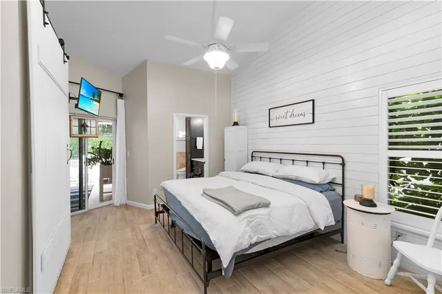 a bedroom with a bed and a large window