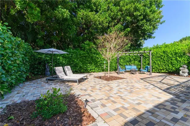 a view of a outdoor space with garden and furniture