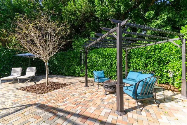 a backyard of a house with table and chairs