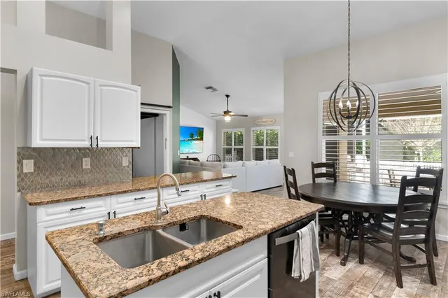 a kitchen with sink cabinets and window