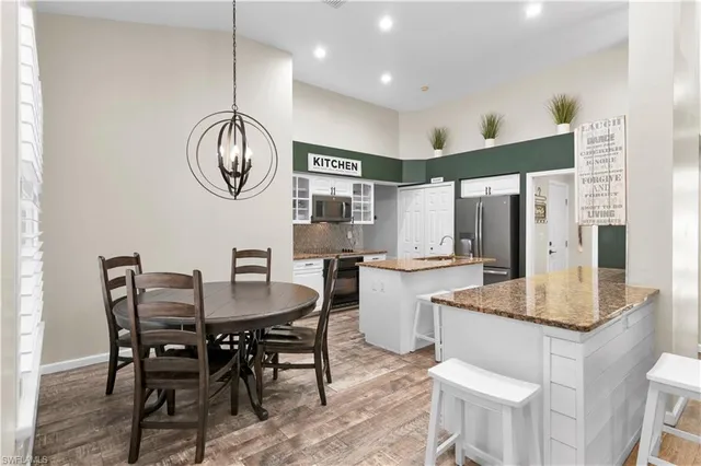 a dining room with granite countertop a table and chairs