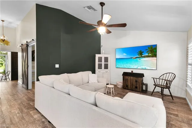 a living room with furniture a ceiling fan and a rug