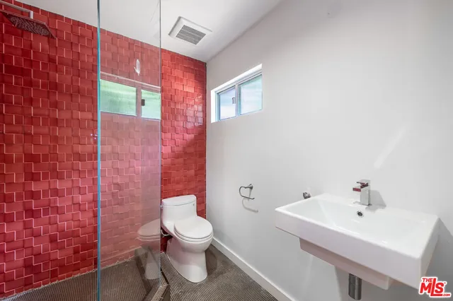 a white toilet sitting next to a bathroom sink