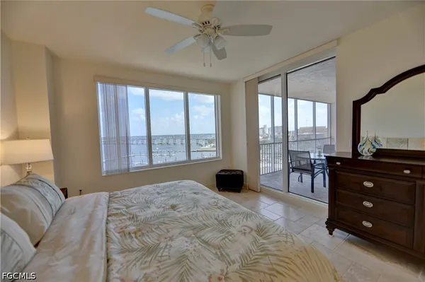 a bedroom with a bed and a large window