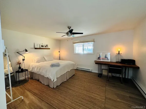 a bedroom with a bed table and window