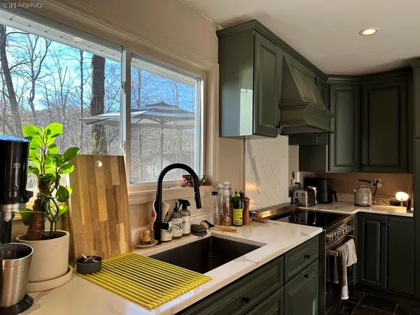 a kitchen with a sink appliances and cabinets