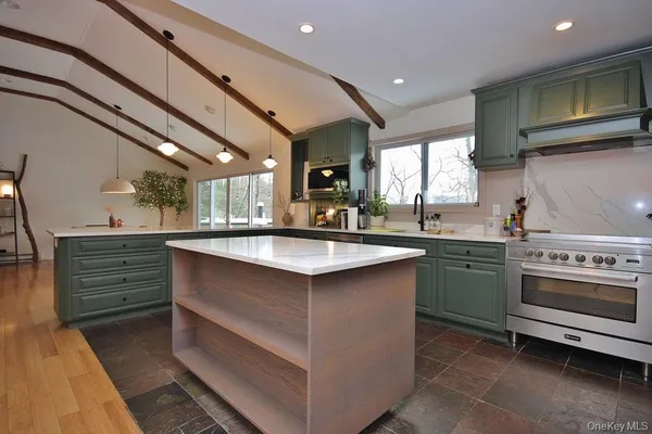 a kitchen with stainless steel appliances granite countertop a sink and stove top oven