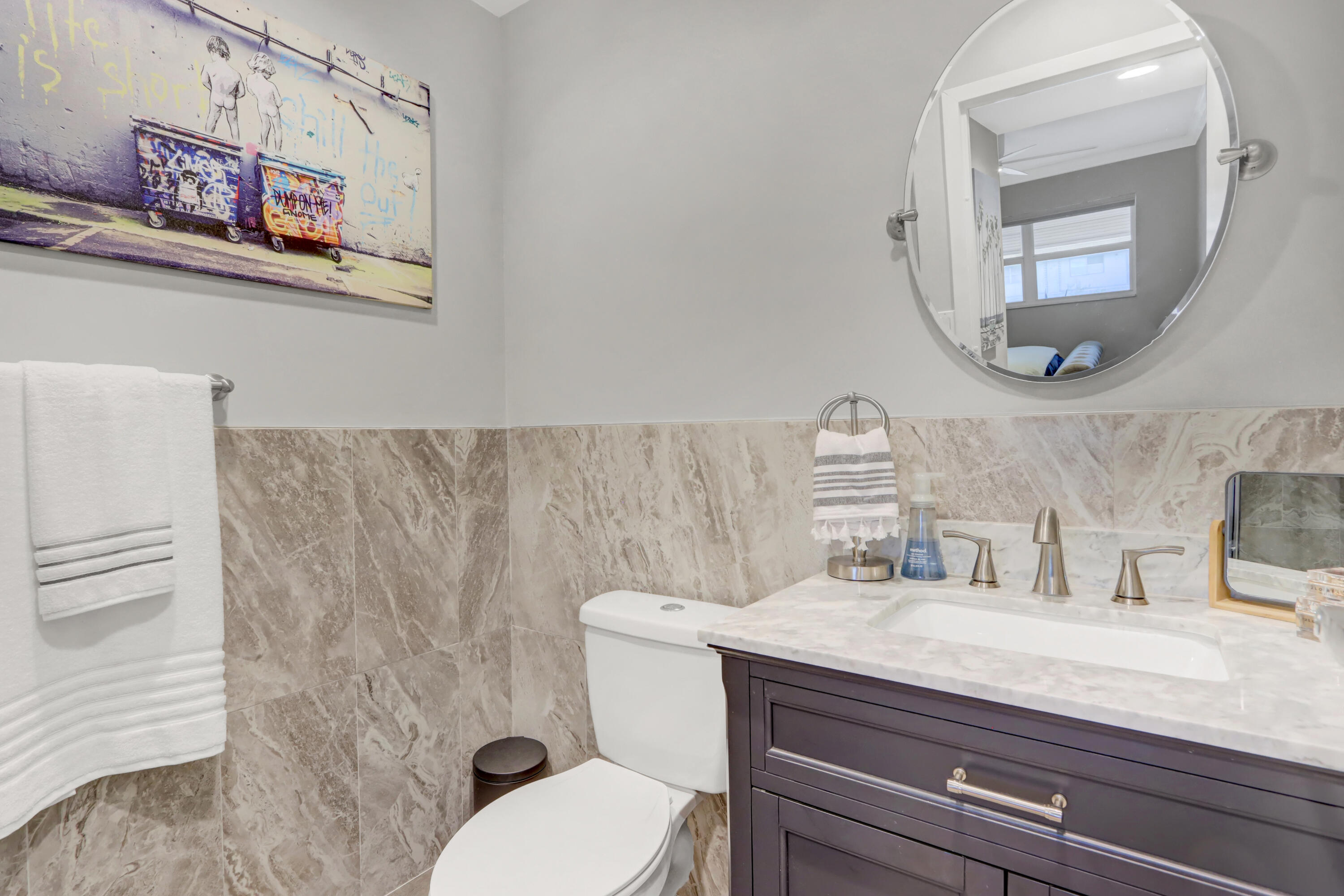 508 Monaco Way Delray Beach, FL 33446 - Photo 14 of 36 a bathroom with a granite countertop toilet sink and mirror