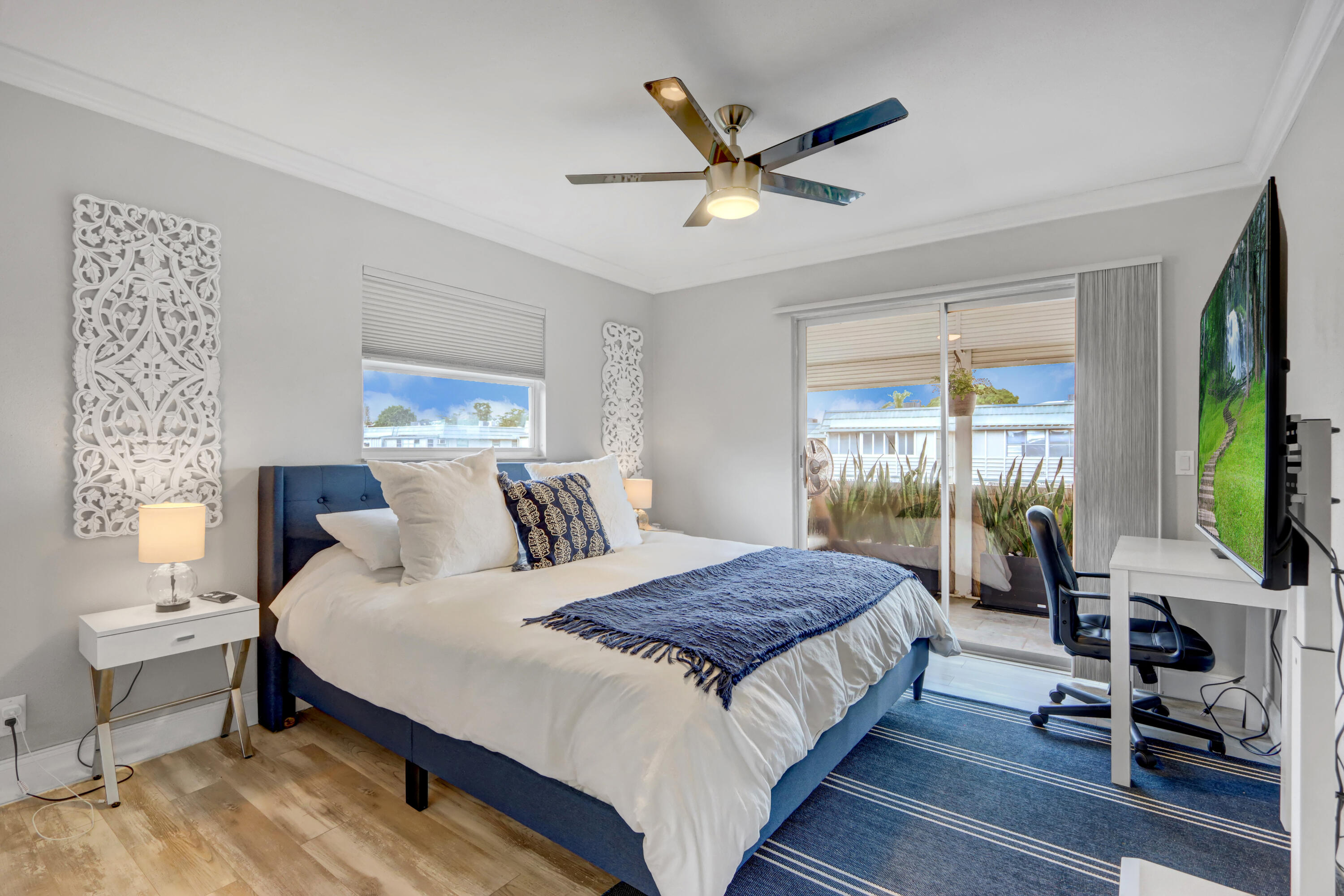508 Monaco Way Delray Beach, FL 33446 - Photo 16 of 36 a bedroom with a large bed a chandelier and windows