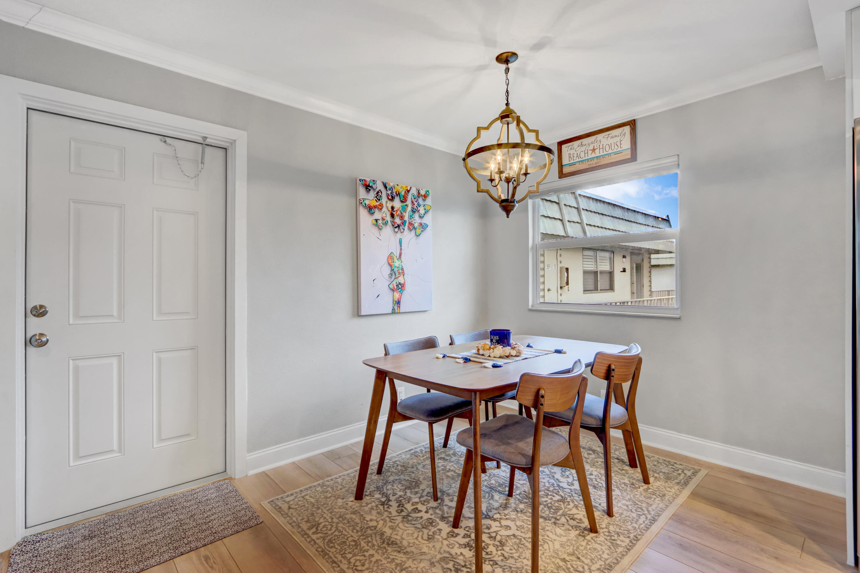508 Monaco Way Delray Beach, FL 33446 - Photo 2 of 36 a view of a dining room with furniture window and wooden floor