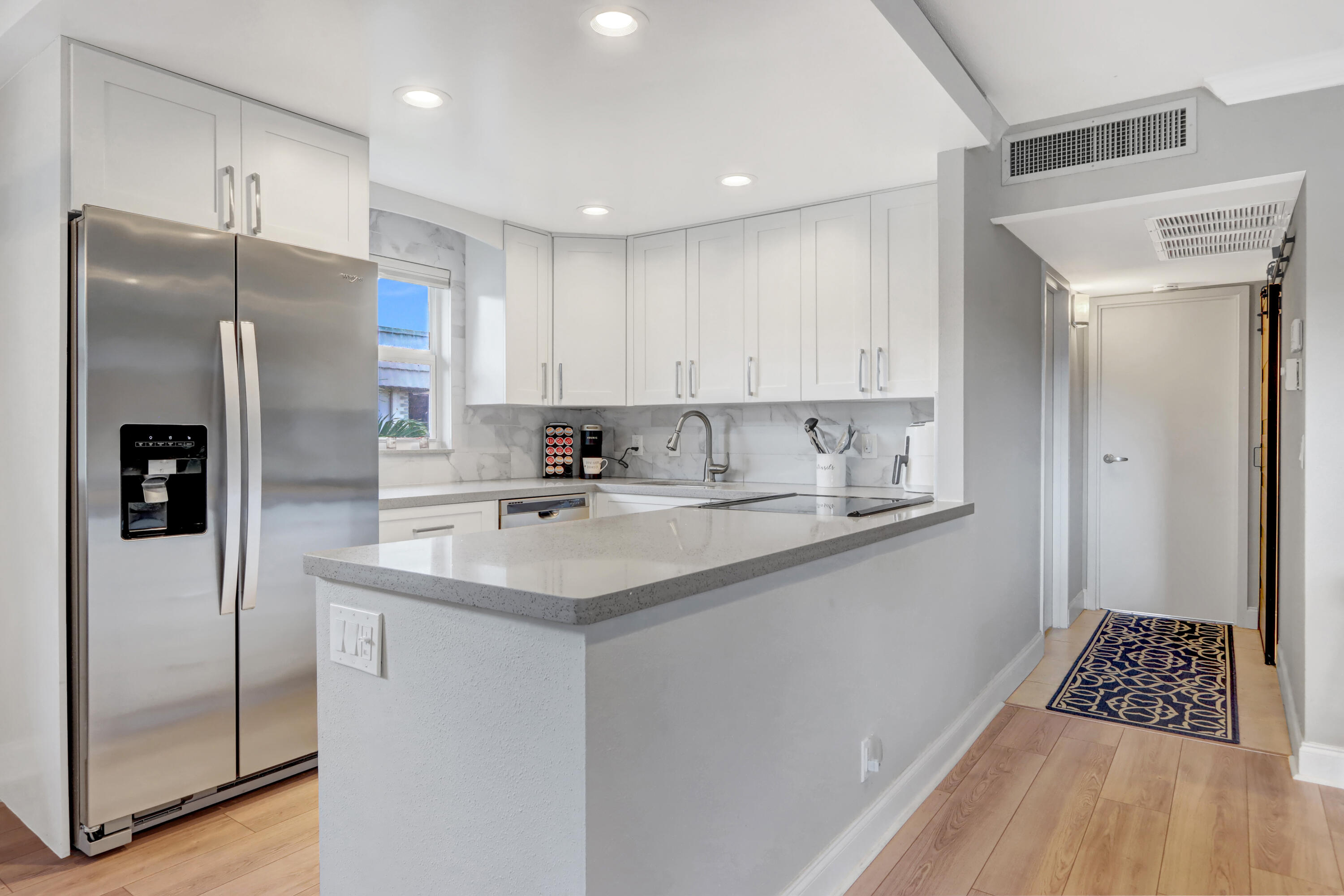 508 Monaco Way Delray Beach, FL 33446 - Photo 5 of 36 a kitchen with stainless steel appliances a refrigerator sink and cabinets