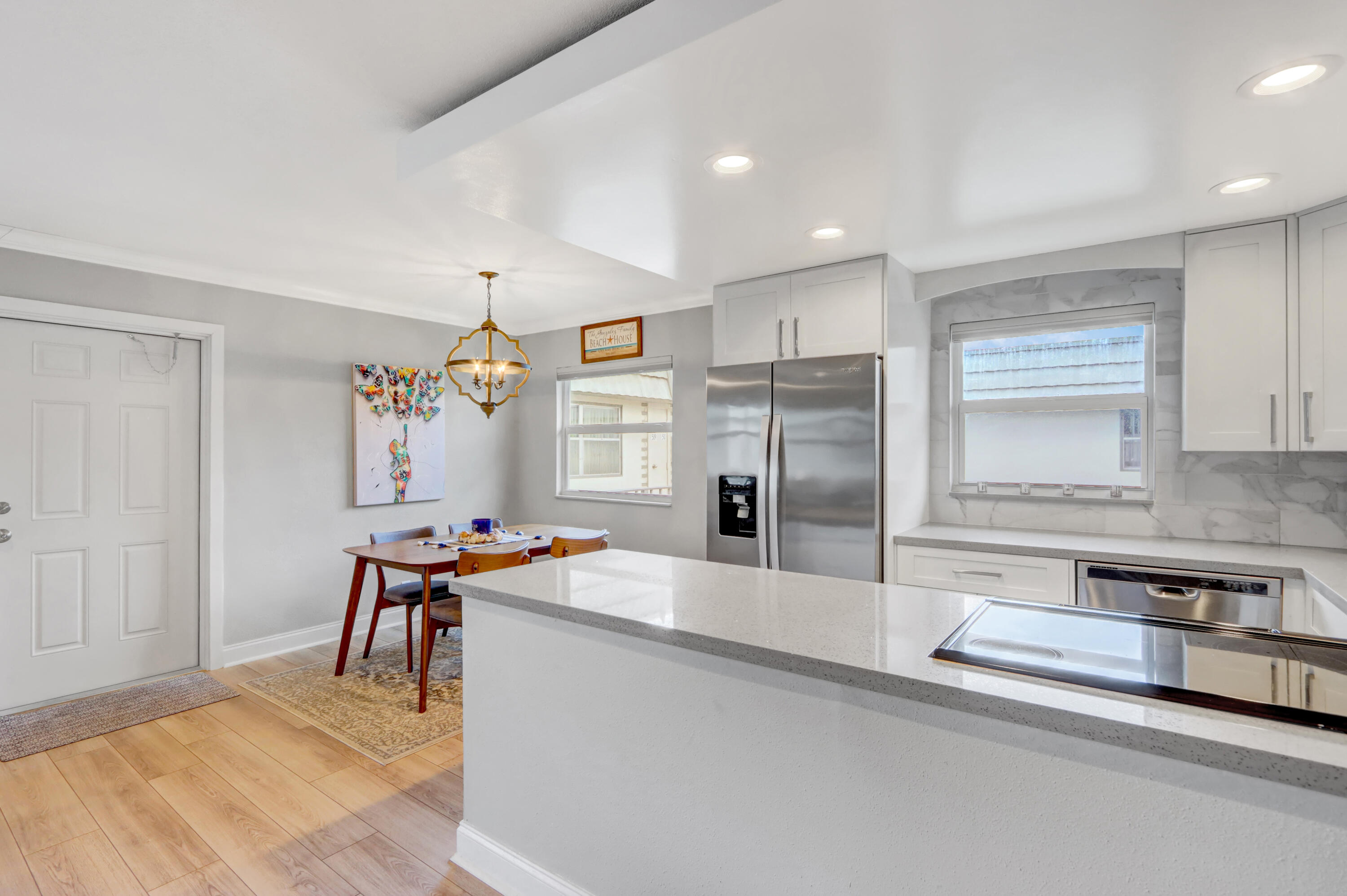 508 Monaco Way Delray Beach, FL 33446 - Photo 6 of 36 a kitchen with stainless steel appliances kitchen island granite countertop a sink and cabinets