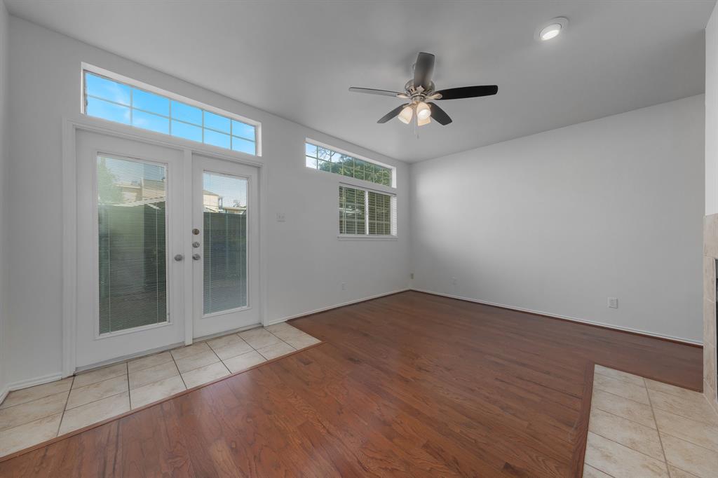 6303 Prospect Avenue, Unit B104 Dallas, TX 75214 - Photo 14 of 36 Living room features lots of windows for great natural light and double doors leading out to private courtyard.