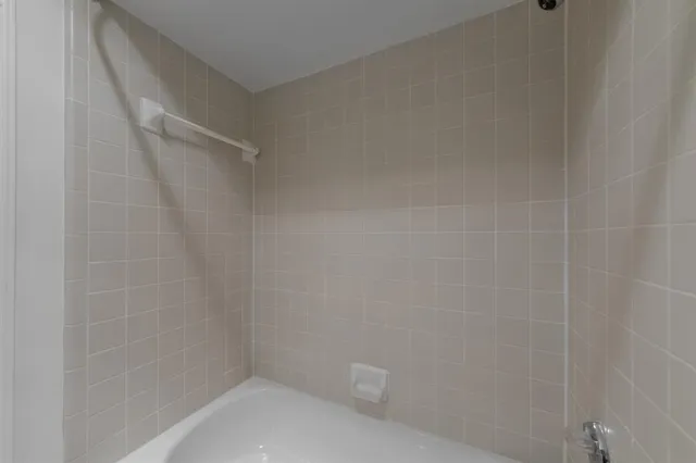 a view of a big room with wooden floor and a ceiling fan