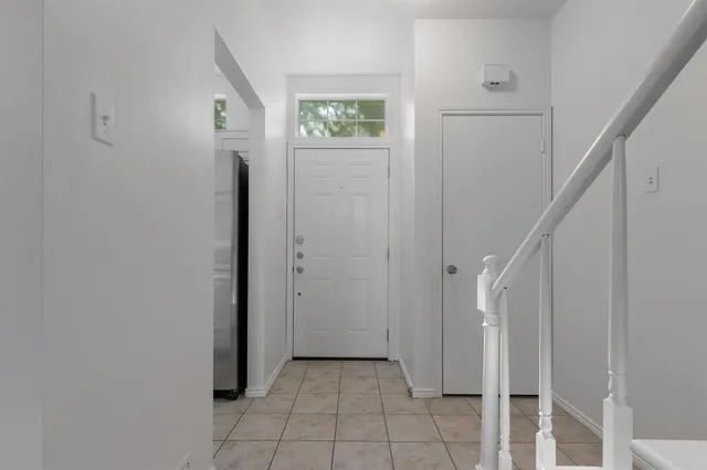 a view of a hallway with closet and entryway