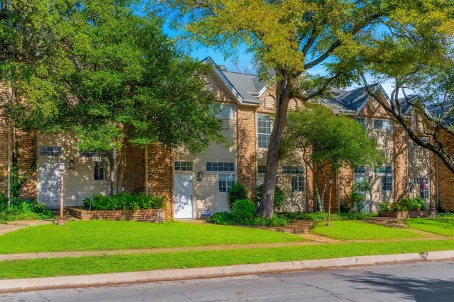a view of a backyard with wooden fence