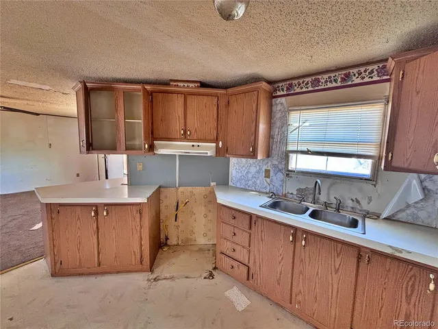 a kitchen with cabinets a sink and appliances