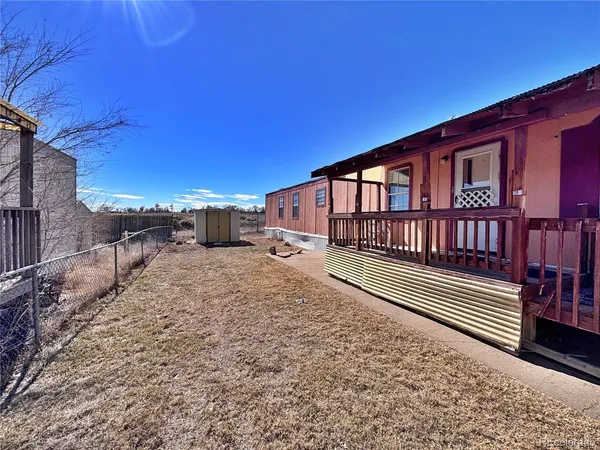 a view of a house with a wooden fence