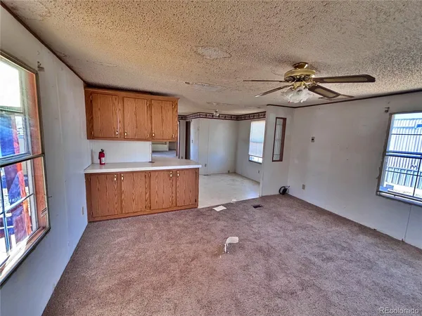 a room with natural light appliances and cabinets