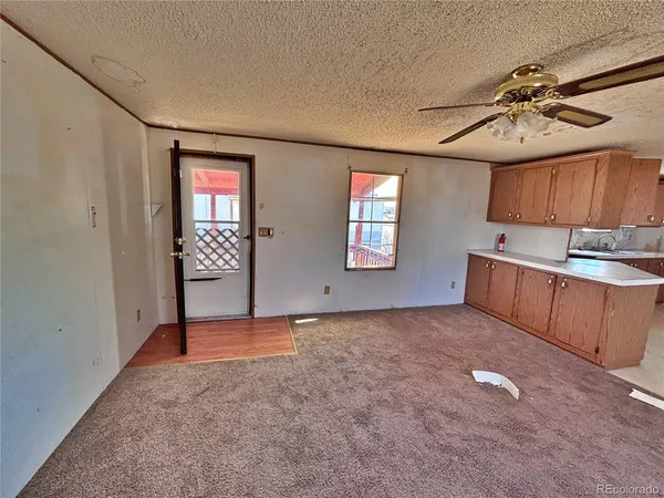 an empty room with windows and cabinet