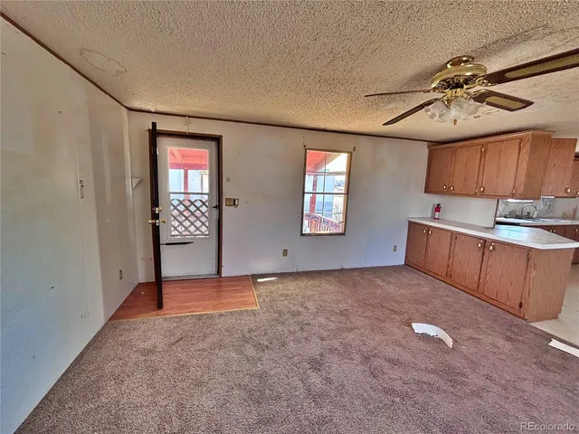 an empty room with windows and cabinet