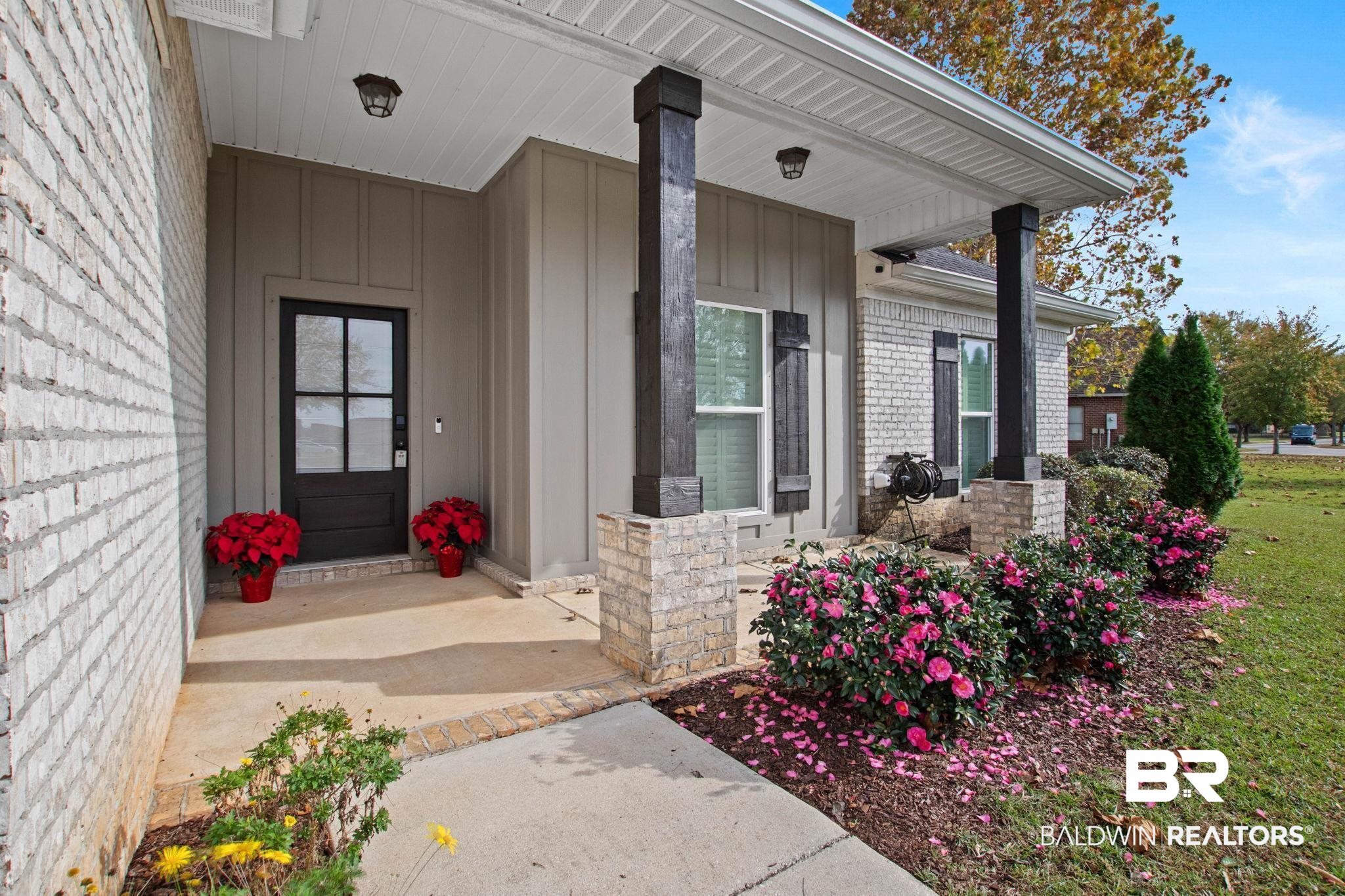 17376 Bankhead Boulevard Fairhope, AL 36532 - Photo 9 of 73 Property entrance with covered porch, board and batten siding, and brick siding