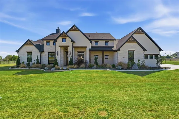 a front view of a house with a yard and porch