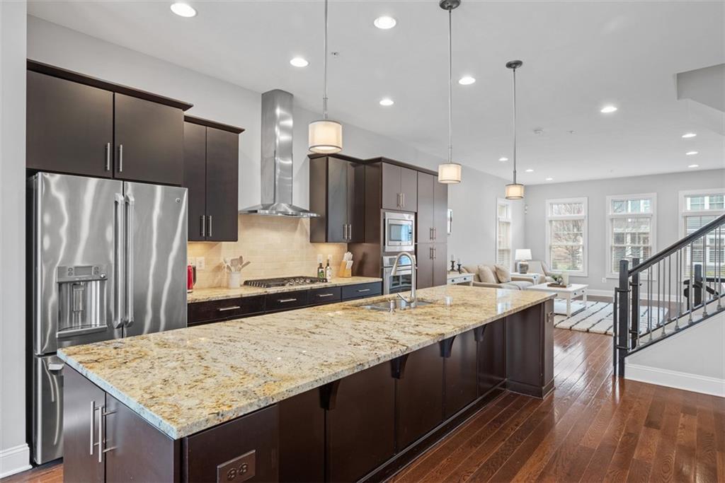 218 Venango Trail Mars, PA 16046 - Photo 6 of 42 a kitchen with kitchen island granite countertop wooden cabinets and refrigerator
