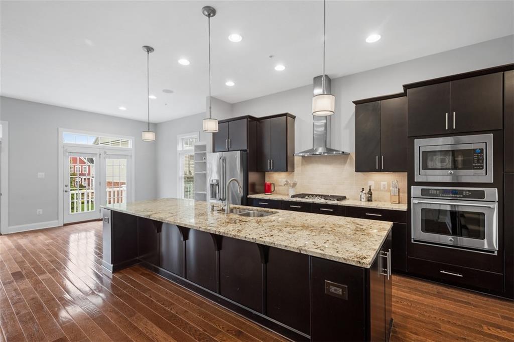 218 Venango Trail Mars, PA 16046 - Photo 7 of 42 a kitchen with stainless steel appliances kitchen island granite countertop a stove a sink and a refrigerator