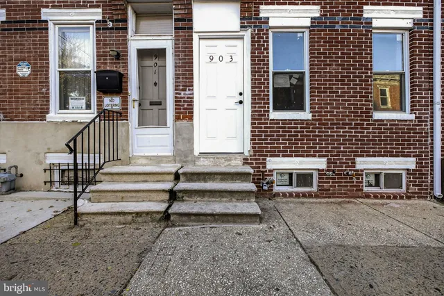 a view of a house with a small deck