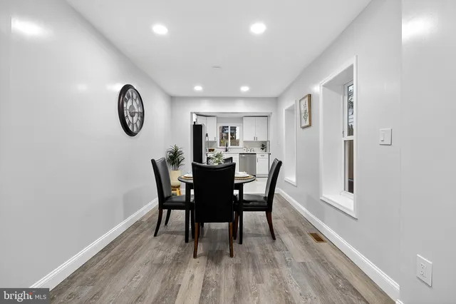 a view of a dining room with furniture window and wooden floor