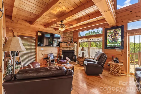 a living room with furniture a fireplace and a flat tv screen