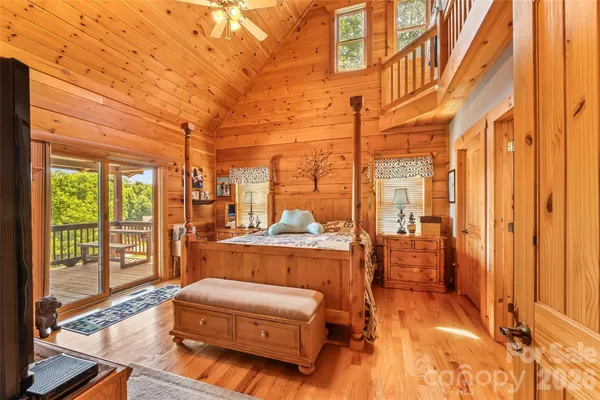 a bedroom with a bed and flat screen tv
