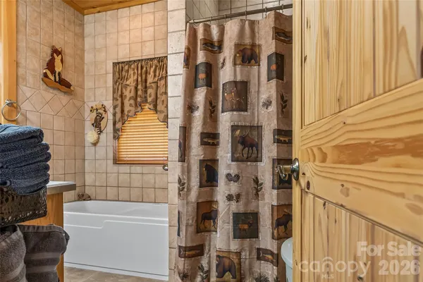 a bathroom with a toilet a sink and a mirror