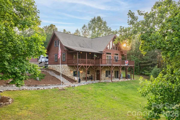 a view of a house with a yard balcony and sitting area