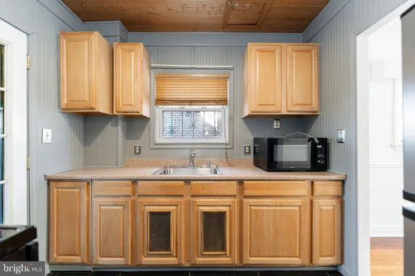 a kitchen with stainless steel appliances granite countertop a sink a stove and cabinets