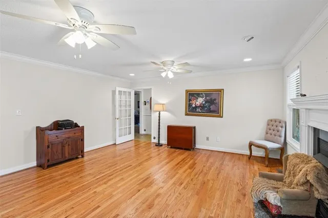 a view of a livingroom with furniture a flat screen tv and wooden floor
