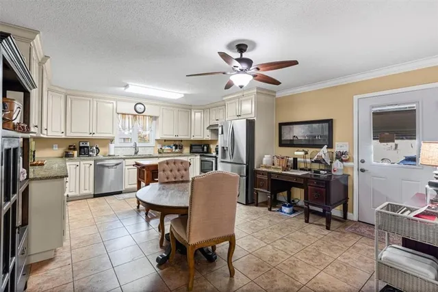 a kitchen with cabinets a counter space stainless steel appliances and a dining table