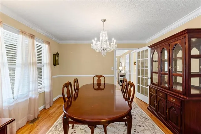 a dining room with furniture a rug and wooden floor