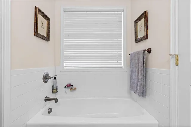 a white bath tub sitting next to a white sink