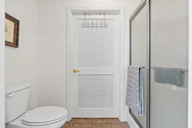 a bathroom with a toilet and shower