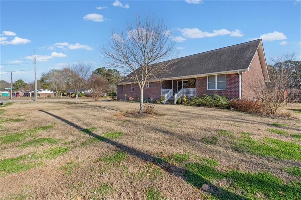 11 Paige Street Cartersville, GA 30121 - Photo 4 of 49 a backyard of a house with large trees and a wooden fence