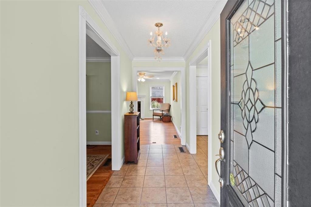 11 Paige Street Cartersville, GA 30121 - Photo 8 of 49 a hallway with a dining table and a chandelier